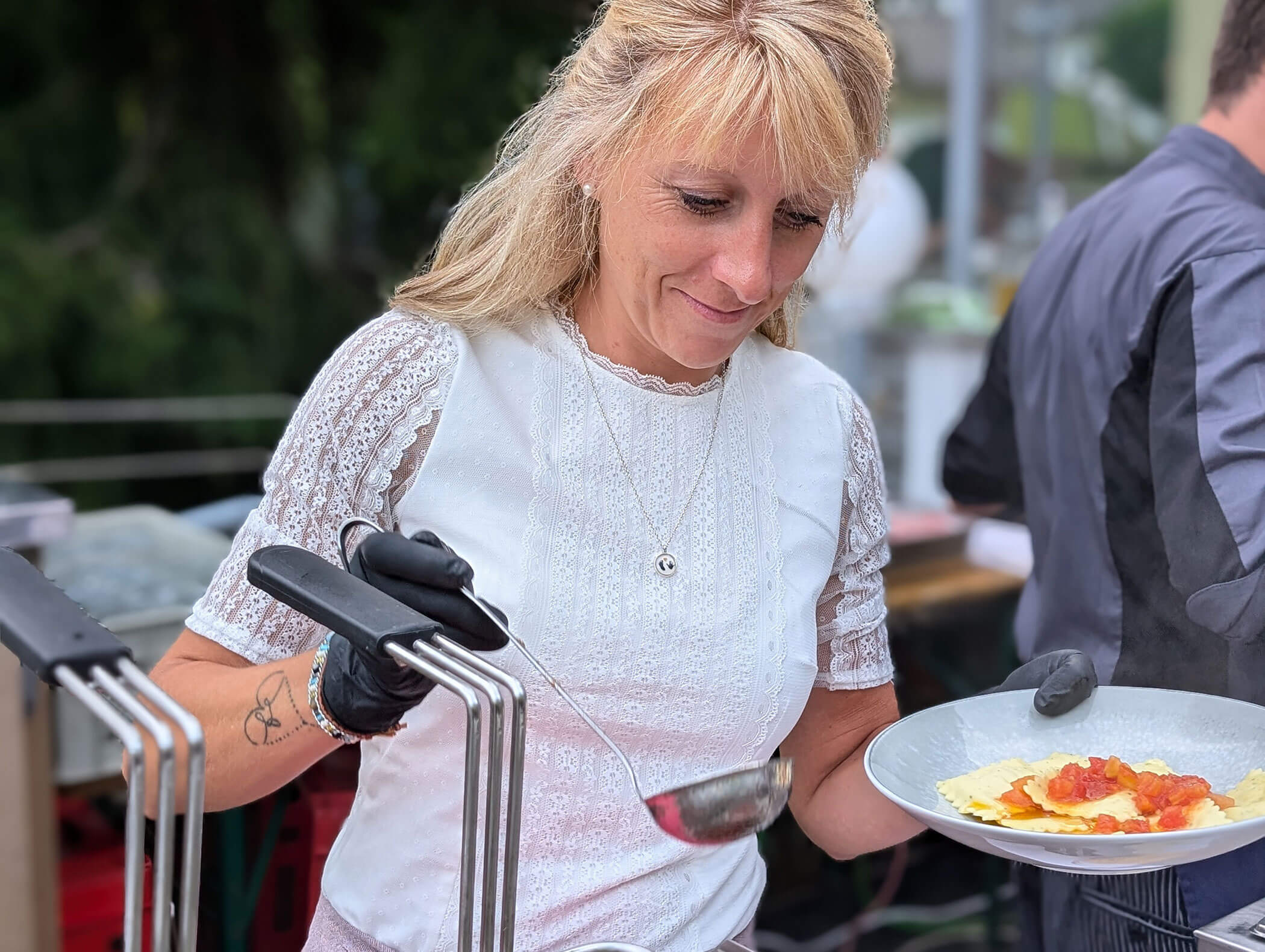 Woman scooping food onto a plate