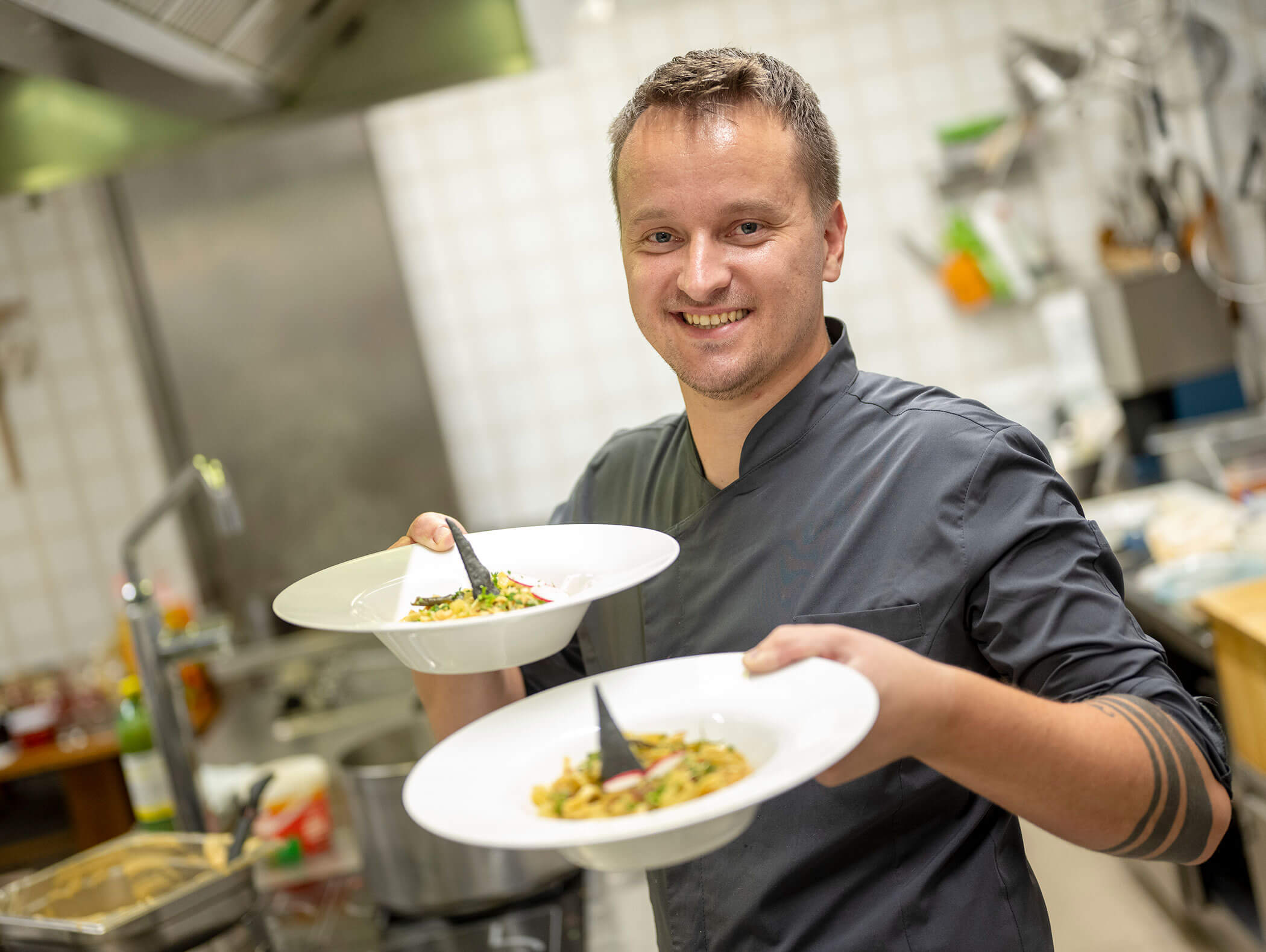 Cook with 2 plates in his hand